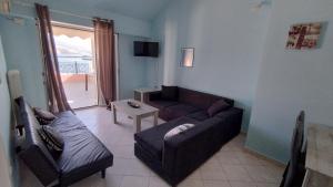 a living room with a couch and a chair at Johanna Sea View Apartment in Lixouri