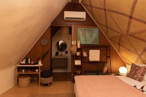a attic bedroom with a bed and a desk at Jinjer Resort in Cavinti +131 photos