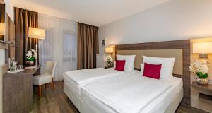Postel nebo postele na pokoji v ubytování PLAZA INN Karlsruhe Nord