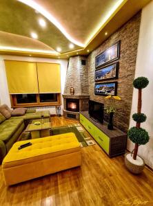 a living room with a couch and a fireplace at Matija LUX Konaci in Zlatibor
