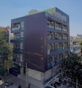 a building with a sign on the side of it at Hotel Kinotree Yeshwanthpur in Bengaluru