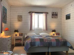 a bedroom with a bed and a window at Villa Stuga in Hammarstrand