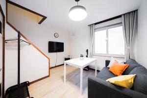 a living room with a couch and a table at Lavender Breeze Furano in Furano