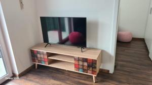 a tv sitting on a stand in a room at Apartament 4You in Żywiec