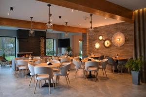 a restaurant with tables and chairs in a room at Pensiunea Amonte in Avrig