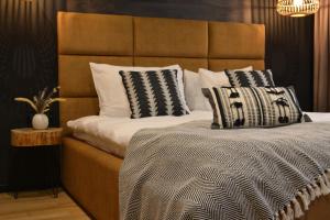 a bedroom with a large bed with a large headboard at Pensiunea Amonte in Avrig +66 photos