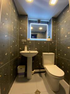 a bathroom with a toilet and a sink at Corner Guest House in Tbilisi City