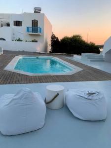 a pair of white shoes sitting on a table next to a swimming pool at The Blue Lagoon Apartment in Aliki