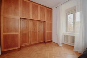 an empty room with wooden cabinets and a window at Altbau-Traum in Feldbach in Feldbach