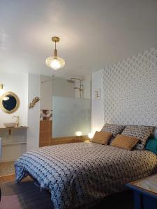 a bedroom with a large bed and a mirror at La Carte Postale in Oye-Plage