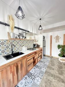 a kitchen with a sink and a refrigerator at L'oiseau vert apartments in Rodrigues Island