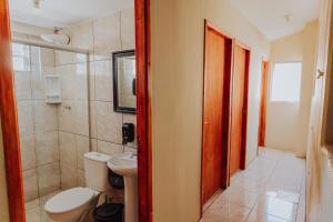 a bathroom with a toilet and a sink at Hostel Casarão Fronteira in Santana do Livramento +34 photos