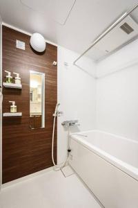 a bathroom with a shower and a mirror at bHOTEL Yutori - Homey w 1BR in Onomichi for 3 Ppl in Onomichi
