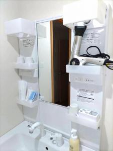 a bathroom sink with a mirror and a microscope at 麗base野芥 in Fukuoka
