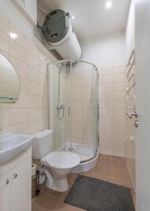 a bathroom with a shower and a toilet and a sink at City Centre 3BD Apartment by Hostlovers in Kaunas