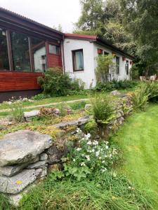 a house with a garden in front of it at Invercassley cottage in Lairg