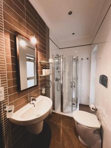 a bathroom with a sink and a toilet and a shower at Pembroke Parkside Maisonette in Pembroke 