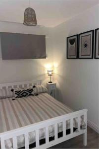 a bedroom with a bed with a tv on the wall at Ty glan y mor in Tremadoc +33 photos