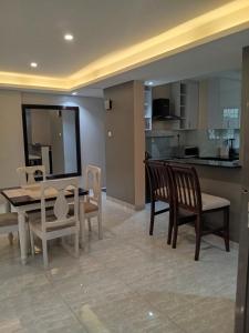 a kitchen and dining room with a table and chairs at SHOAL Apartments, Mawanda Road in Kampala