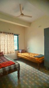 a bedroom with two beds and a window at Funky Buddha Hostel in Mysore