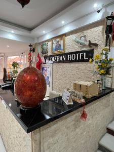 a hotel lobby with a large apple on the counter at YILDIZHAN HOTEL in Pamukkale