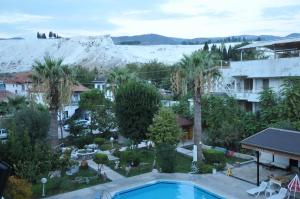 a view of a resort with a pool and a mountain at YILDIZHAN HOTEL in Pamukkale