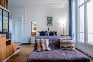 a bedroom with a bed with two pillows on it at Le Brillant - Studio in Reims