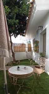 a patio with a table and chairs and a hammock at Nao Victoria in Gelves