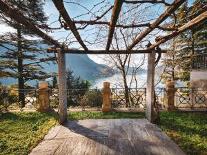 an open gate with a view of a mountain at La Castignola con vista lago di Lugano e giardino condiviso in Lugano