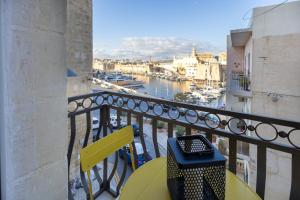 a balcony with a table and a view of a harbor at Sea View 34 in Birgu