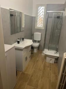 a bathroom with a sink and a toilet and a shower at GL Sun Palace in Bari