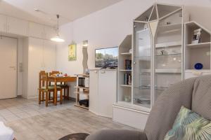 a kitchen and dining room with a refrigerator and a table at 50060... in Harlesiel