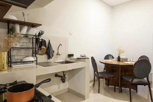 a kitchen with a sink and a table with chairs at Cebu city entire place for family or party in Cebu City