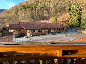 a large house with a roof on a mountain at Selský Dvůr Perštejn in Perštejn