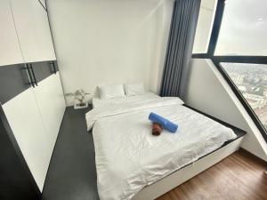 a small room with a bed with a blue box on it at Chiu Housestay Ha Long in Ha Long