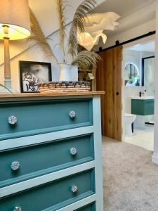 een blauwe dressoir in een kamer met een badkamer bij Blas at Fronlas Café - The heart of Newport in Newport