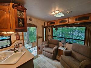 a kitchen and living room of an rv at The Mountaineer (Presque Isle Campground #4) in Presque Isle