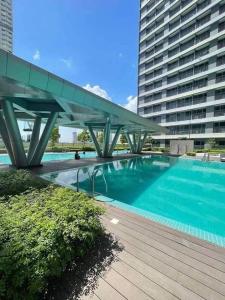 a bridge over a swimming pool in a building at Condo at Greenfield in Manila