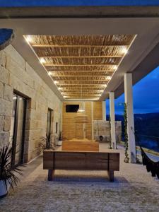 a room with a couch and a tv on a building at Casa do Barqueiro TREIXADURA in Castrelo de Miño