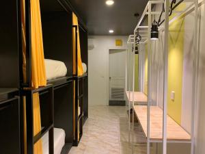 a room with two bunk beds and a hallway at The Hive Hotel in Siem Reap