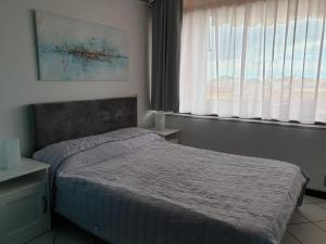 a bed in a room with a window and a bed sidx sidx sidx at Residence le Dune in Lido di Camaiore