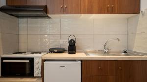 a kitchen with a sink and a counter top at Stone Manor 2 in Kastrákion +21 photos