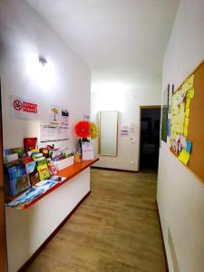 an office with a reception counter and a hallway at B & B La Mela in Darfo