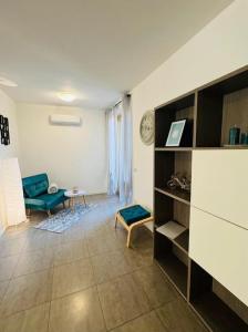 a living room with a blue couch and a table at L'oro del lago monate lake - Ixihome in Travedona