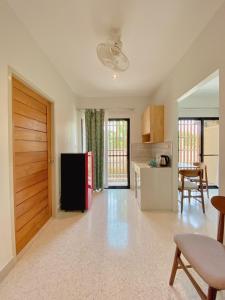 a kitchen and living room with a red refrigerator at Calamint Residence Hotel ( คาลามิ้นท์) in Chumphon