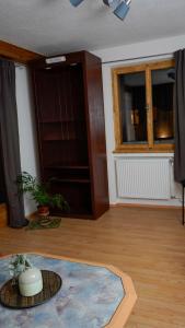 a living room with a table and a window at Apart Weitblick in Ladis