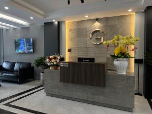 a lobby with a reception desk with flowers on it at G Hotel Sai Gon in Ho Chi Minh City