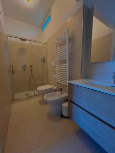 a bathroom with a toilet and a shower and a sink at Capri Melody in Anacapri