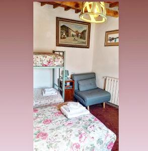 a bedroom with a bunk bed and a chair at Antica Dimora Il Murrotto in Lanciole