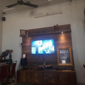 a large flat screen tv on a wall at Premanand's House in Raipur